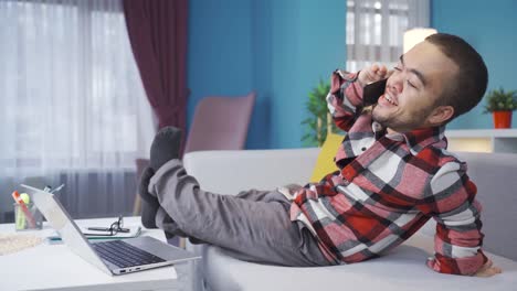 Cheerful-and-funny-disabled-dwarf-young-man-chatting-on-the-phone-at-home.